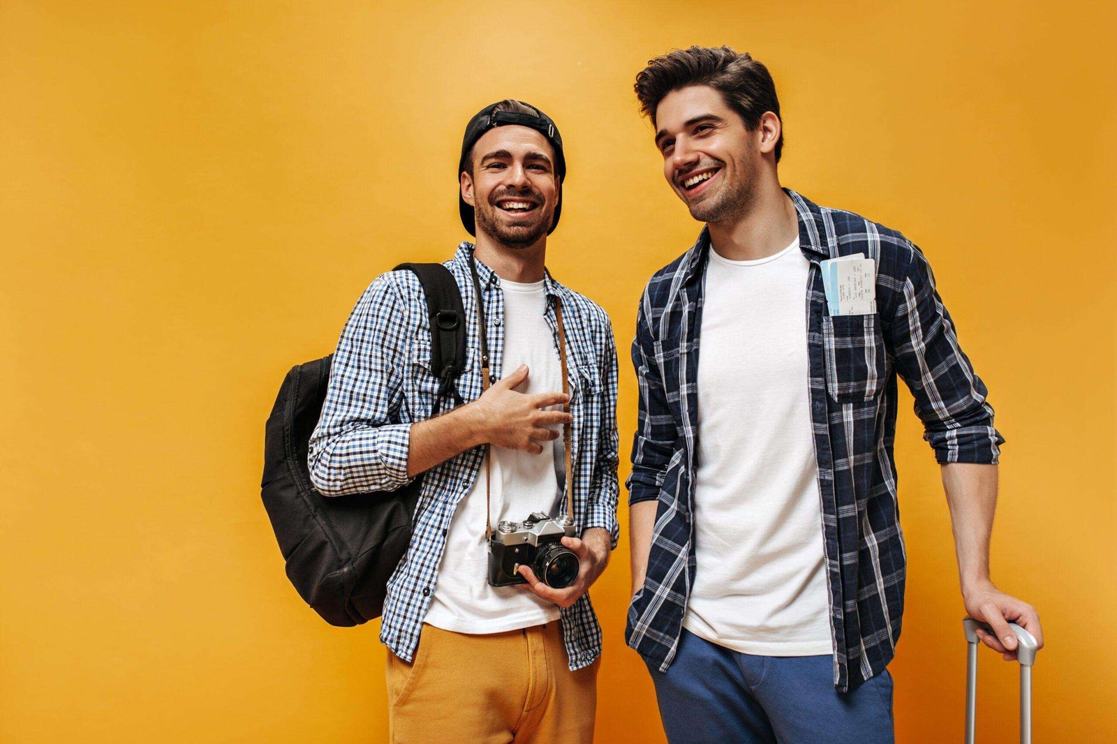 Good-humored young brunet men in checkered shirts and white t-shirts smile on orange background. Ch – nicotine pouches snus Casablanca Maroc